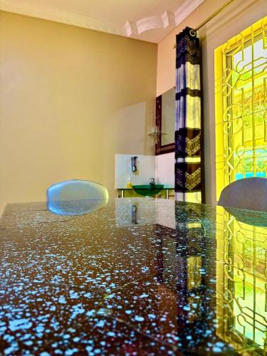 a dining room with a glass table and chairs at Isamilo House in Mwanza