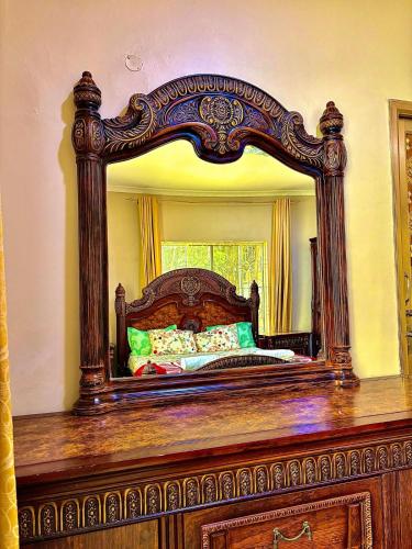 a large mirror on top of a wooden table at Isamilo House in Mwanza