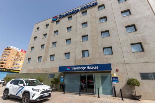 a car parked in front of a hotel at Travelodge Málaga Airport in Málaga