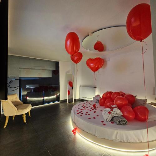 a room with red balloons and a bed with a bed at Christian's Suites & Spa in Fasano