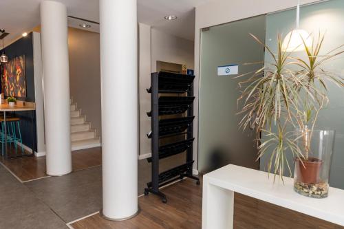 a room with a white pillar and a plant at Travelodge Málaga Airport in Málaga