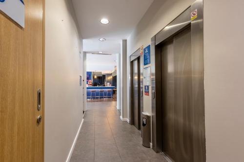 a corridor of a hospital hallway with a hallway at Travelodge Málaga Airport in Málaga