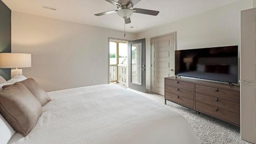 a bedroom with a large bed and a flat screen tv at Landing at Cove at Pine Ridge - 1 Bedroom in Lyman in Lyman