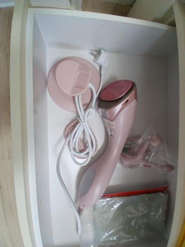a white and pink hello kitty hair dryer in a drawer at Gangane Anjirang in Daegu