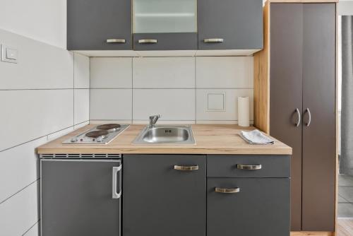 Kuchyň nebo kuchyňský kout v ubytování cozy city retreat