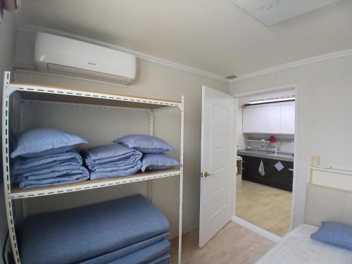 a room with a bunk bed with blue pillows at Gangane Anjirang in Daegu