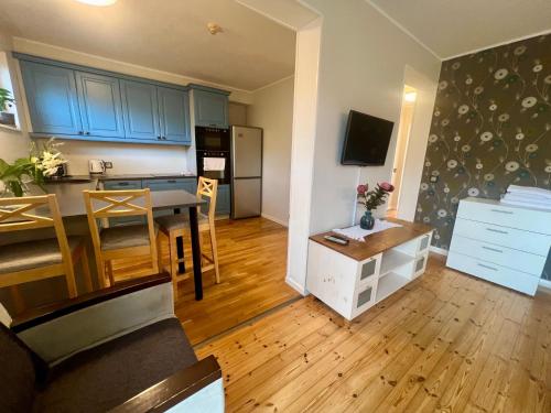 a kitchen and living room with a dining room table and a kitchen at Villa Meri Apartments in Pärnu
