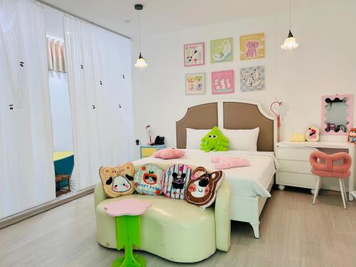 a childs bedroom with a bed and a chair at Pisces Hotel Hue in Hue
