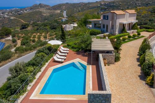 an aerial view of a villa with a swimming pool at Luxury Villa Hara with private pool in Agia Pelagia