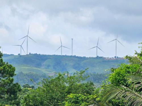 a group of wind turbines on top of a hill at Norn nee Na Hostel นอน นี่ นะ โฮสเทล in Ban Non Na Yao
