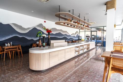 a restaurant with a mountain mural on the wall at New 1 Bdr Royal Lee Nayang beach in Ban Bo Han