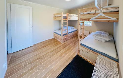 a small room with bunk beds and a closet at Nice Home In Åstenäs With Wifi 