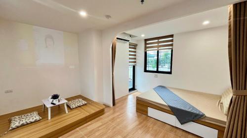 a bedroom with a bed and a table at Era Apartment Tam Da in Hanoi