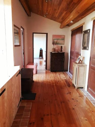 a living room with a wooden floor and wooden ceilings at Grand Gite De Gascogne - 12 Places 
