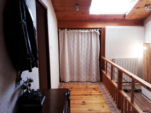 a room with a staircase with a curtain and a window at Grand Gite De Gascogne - 12 Places 