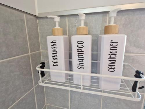 three bottles ofodorizers are on a shelf in a bathroom at NEU! FeWo AllerGrün, Balkon mit Blick in die Natur in Borstel