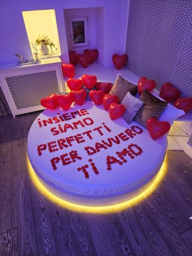 a cake in the middle of a room with hearts on it at Christian's Suites & Spa in Fasano