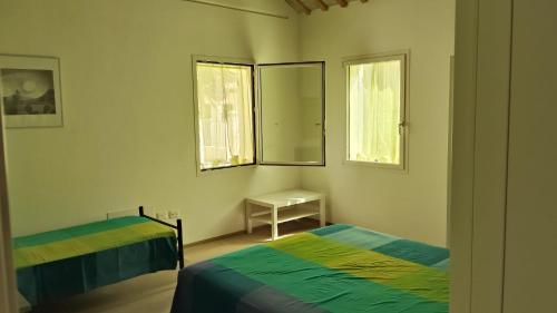 a bedroom with two beds and a mirror at La Casa di Lory in Senigallia