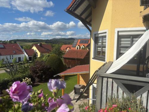 a view from the balcony of a house with purple flowers at Schwarzachtal Oase in Neunburg vorm Wald