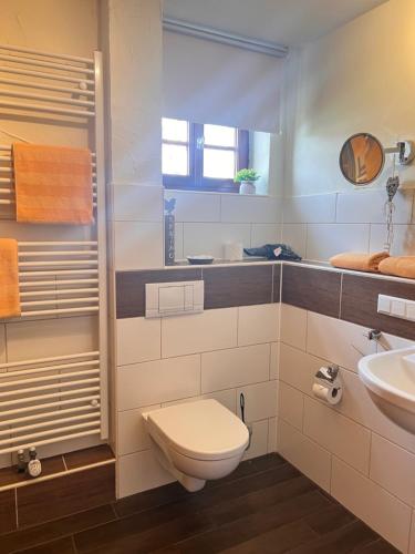a bathroom with a toilet and a sink at Landhotel im Hexenwinkel in Wiernsheim