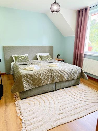 a bedroom with a large bed with a rug at AINO Hotel in Pilipets