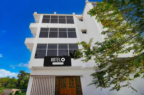 a white building with a kaloo sign on it at Hotel O Howrah Botanical Garden in Kolkata