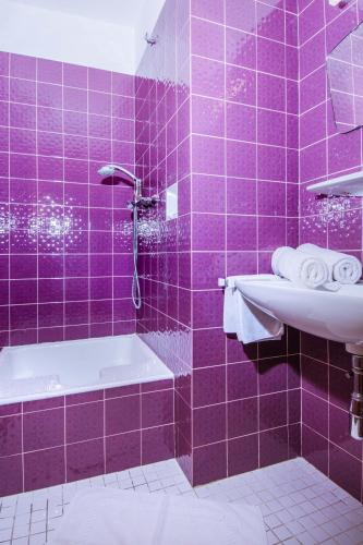 a purple bathroom with a tub and a sink at Ferienhaus Kuchelberg in Altenmarkt im Pongau