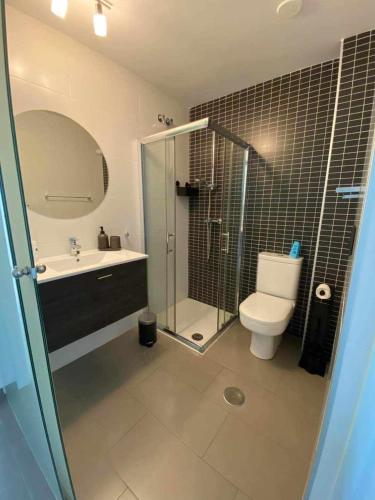 a bathroom with a shower and a toilet and a sink at Viva La Zenia in Orihuela Costa
