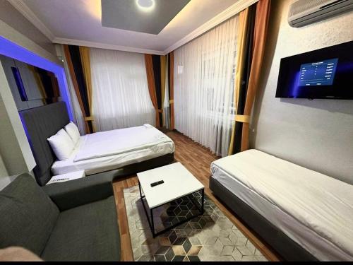 a small room with two beds and a couch at Link Taksim Hotel in Istanbul