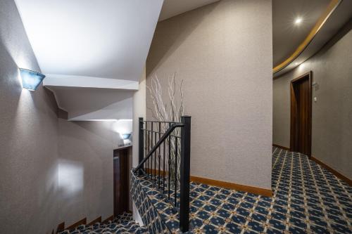 a hallway with a stairwell with a staircase at Hotel Central in Nyíregyháza