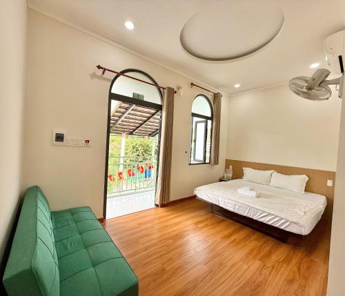 a bedroom with a bed and a large window at Homestay Làng Biển in Ninh Hải