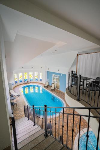 a large swimming pool in a building at Hotel Central in Nyíregyháza