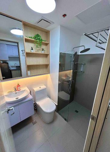 a bathroom with a toilet and a sink and a shower at FREE Parking City lights AlexaVoice Control Unit in Manila