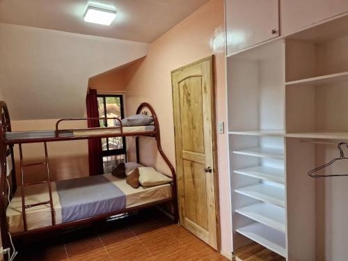 a room with bunk beds and a closet at 3 Bedrooms 2 storey House in Dipolog