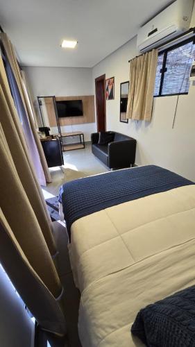 Postel nebo postele na pokoji v ubytování Hotel Flores de Holambra