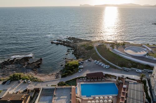 an aerial view of a resort and the ocean at Hotel Calabona in Alghero