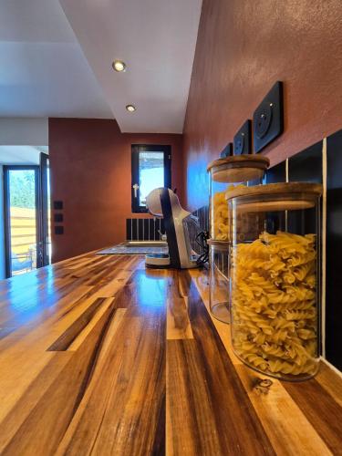 a room with a wooden floor and a room with yellow food at Mini Loft à la campagne La MEXI K-LINE in Entrecasteaux