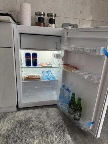 an open refrigerator with drinks and bottles of water at Stan na dan Raška in Raška