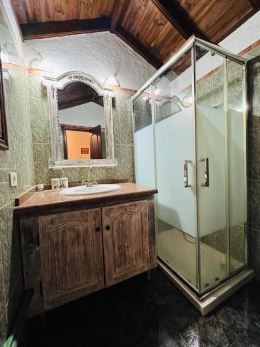 a bathroom with a shower and a sink and a mirror at Balcones de Erques in Guía de Isora