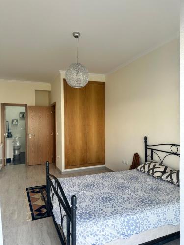 a bedroom with a bed and a chandelier at Atlantic Foz in Buarcos