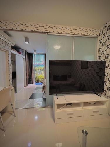 a living room with a large flat screen tv at Stylish Bangkok Condo Furnished, Pool View Prime Location in Ban Nong Chaeng