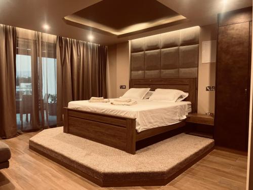 a bedroom with a large bed with white sheets at Oasis Penthouse Luxury Suite in Limassol