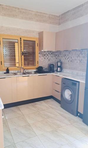 a kitchen with a washing machine in a kitchen at Villa Dar Rayan & Naelle in Midoun