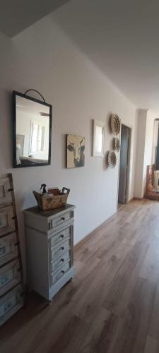 a room with a dresser and a mirror on the wall at Maison Calme Lavande et coquelicots in Saint-Jean-Pla-de-Corts