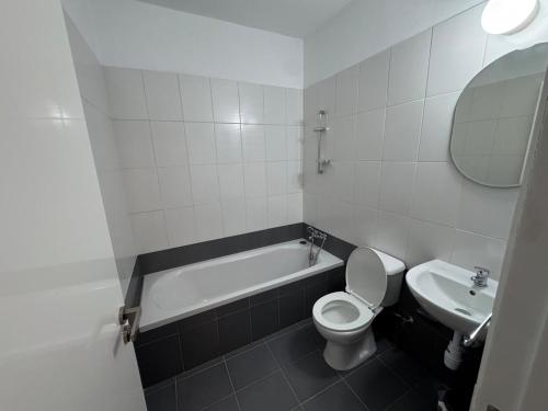 a bathroom with a toilet and a tub and a sink at Peyia Sunset Luxury in Paphos City