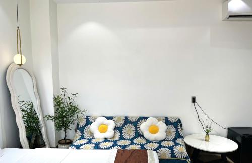 a room with a couch with a pillow with eggs on it at Lucasta Hotel in Can Tho