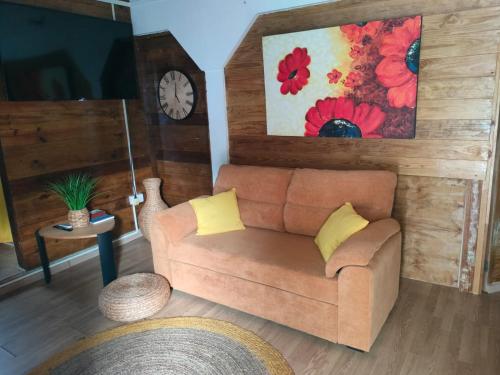 a living room with a couch and a clock at portsmouth Cottage Haven Escapes in Portsmouth