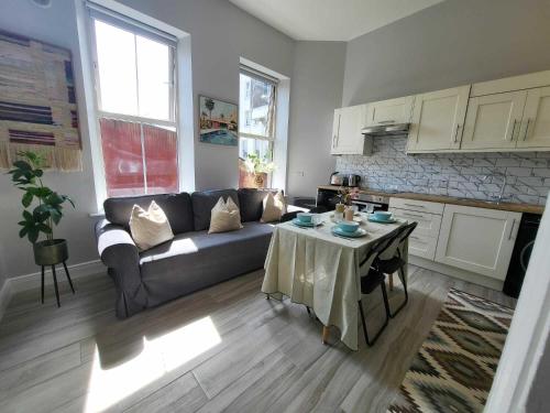 a living room with a couch and a table at Top Location - Newly Refurbed 2BD Sleeps 6 W Loft in Cork