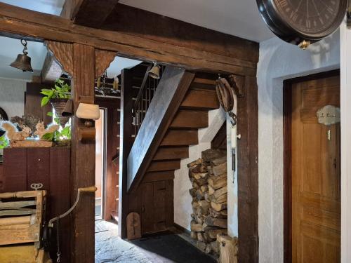 a staircase in a room with a pile of wood at Refuge du Poète in Longueuil