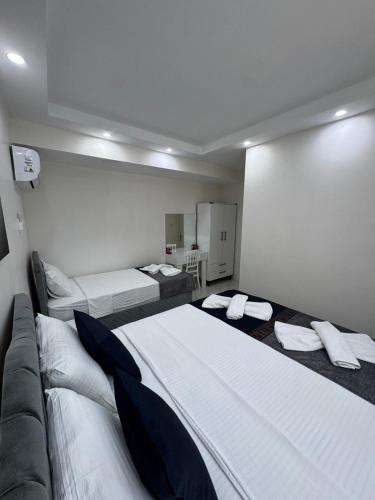 a hotel room with two beds and a couch at PRETTY HOUSE in Pamukkale
